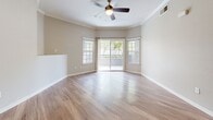 Located at 600 Rohnert Park Expressway in Rohnert Park, California, this single-floor residence offers a thoughtfully designed layout with a clean, modern aesthetic throughout. The open living area is anchored by gleaming wood-look hardwood flooring, crown molding, and a ceiling fan, while a wall of windows and a sliding glass door invite abundant natural light and provide direct access to an outdoor patio with views of lush greenery.

The kitchen is efficiently designed with a galley-style layout featuring white shaker cabinetry, granite countertops, stainless steel appliances including a full-size refrigerator and dishwasher, and wood-look flooring that flows seamlessly through the space. Adjacent storage with wire shelving offers generous organizational capacity.

The bedrooms are carpeted in neutral tones and offer a calm, comfortable retreat. Each room includes large windows that bring in natural light, and six-panel doors add a classic architectural touch. The bathrooms are finished with white vanity cabinetry, granite countertops, and large mirrors — one bathroom features hardwood-style flooring and a well-lit vanity with stylish hardware, while the second offers a more compact, equally refined layout. Together, the spaces create a cohesive, comfortable living environment with quality finishes throughout.
