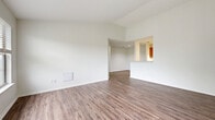 Located at 201 Union Hill Cir in West Carrollton, Ohio, this single-floor, 2-bedroom, 2-bathroom residence offers a practical and comfortable layout across a well-utilized footprint. The open living area features wood-look plank flooring and crisp white walls, creating a bright, clean atmosphere. A pass-through counter connects the living space to the kitchen, which is equipped with warm honey-toned cabinetry, white appliances including a range and refrigerator, and a built-in microwave. The adjacent dining area flows naturally from both the kitchen and living room. The primary bedroom is a generously sized retreat featuring three large windows that invite abundant natural light and offer leafy outdoor views, complemented by wood-look flooring. The second bedroom features plush carpeting, a sizable closet with wire shelving, and a window with outdoor views. Both bathrooms are cleanly finished, with one featuring a soaking tub and shower combination. The residence includes four closets throughout for exceptional storage, as well as a dedicated laundry area with washer hookups and overhead wire shelving. A balcony provides outdoor access, rounding out this well-appointed home.