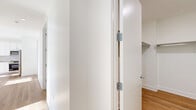 Located at 8601 Bergenline Avenue in North Bergen, NJ, this thoughtfully designed two-bedroom, one-bathroom residence offers a clean, modern aesthetic throughout. Warm hardwood flooring flows seamlessly across the entire single-floor layout, complementing the bright, white walls and contemporary trim work.

The open-concept kitchen and living area serves as the heart of the home, showcasing white shaker cabinetry, a textured tile backsplash, sleek stone countertops, a kitchen island, and a full suite of stainless steel appliances. Natural light pours in generously, enhancing the airy feel of the shared living space.

Both bedrooms are well-proportioned and sun-filled, benefiting from large floor-to-ceiling windows that frame impressive panoramic views of the surrounding neighborhood and the New York City skyline beyond. Each room is served by generous closet space, including a spacious walk-in closet with built-in chrome shelving and hanging rods.

The bathroom is elegantly appointed with full marble-effect tile on the floors and walls, a soaking tub with a handheld shower, a glass-enclosed walk-in shower, an LED-backlit vanity mirror, and a white cabinetry vanity with stone countertops. A dedicated laundry area adds everyday convenience. This residence combines refined finishes with practical functionality in a prime North Bergen location.