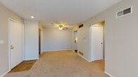 Located at 1881 Solera Dr in Columbus, Ohio, this single-floor residence offers a practical and comfortable layout designed for everyday living. The open living area is finished with neutral-toned wall-to-wall carpeting and features a ceiling fan with light fixture, providing both comfort and airflow. A large sliding glass door with vertical blinds allows natural light to fill the space and provides access to the outdoors. The galley-style kitchen is efficiently arranged with white cabinetry, warm wood-tone countertops, and wood-look flooring. It is equipped with a full suite of white appliances, including a refrigerator, electric range, and dishwasher, along with a double-basin sink. The bedroom is generously sized with soft carpeting, a ceiling fan, and a closet with sliding doors offering built-in shelving for ample storage. The full bathroom includes a single-sink vanity with white cabinetry, a tiled shower-tub combination, and wood-look flooring that ties the space together cleanly. Throughout, the residence maintains a consistent, neutral color palette with textured ceilings, creating a cohesive and move-in-ready atmosphere.