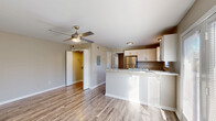 Located on Lantern Ridge Drive in Lincolnton, NC, this single-floor, one-bedroom, one-bathroom residence offers a thoughtfully designed layout that maximizes every inch of its compact footprint. The open-concept main living area seamlessly connects the living room, dining space, and kitchen, creating a bright and functional hub for daily living. Durable wood-look flooring runs throughout the main area, complemented by a ceiling fan that adds both comfort and style.

The kitchen is a standout feature, outfitted with crisp white cabinetry, granite-style countertops, a peninsula breakfast bar, stainless steel refrigerator, dishwasher, and electric range. A window above the sink allows natural light to fill the space.

The bedroom is a comfortable retreat with plush wall-to-wall carpeting, a double-door closet providing ample storage, and a window that brings in natural light. The full bathroom continues the cohesive design with granite-style countertops, white cabinetry, a single vanity sink, and a full soaking tub. Wood-look flooring ties the bathroom together neatly.

Additional conveniences include a dedicated laundry area and an extra closet for storage. Neutral wall tones and clean finishes throughout give the space a move-in-ready appeal.