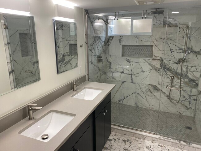 primary bathroom with heated floors dual sinks and dual shower heads - 7200 E 6th Avenue Pky