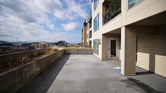 Patio with view of Lumen Field, T-Mobile Stadium and water. - 900 S Jackson St