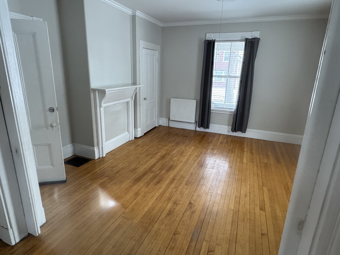 Front parlor. Could be used as living room or second bedroom. Room separated by two pocket doors. - 34 Elm St