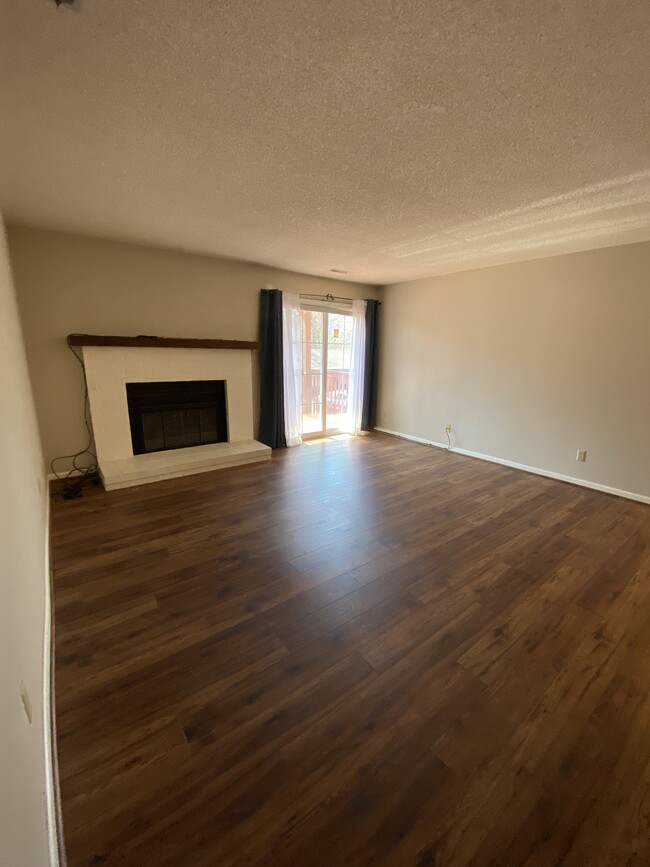 Living room with fireplace and balcony entryway - 3019 SW Maupin Ln