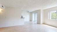 Located at 2405 Mohawk St in Pasadena, CA, this 2-bedroom, 2-bathroom single-level home offers a bright and efficiently designed living space. Light wood flooring runs throughout, complementing the clean, neutral palette of white walls and textured ceilings. The open living and dining area is spacious and airy, featuring a ceiling fan and a sliding glass door that fills the room with natural light and leads to a private balcony. The kitchen is well-appointed with white cabinetry, granite-style countertops, stainless steel appliances including a range and refrigerator, a mosaic tile backsplash, and a peninsula that connects to the dining area. A dedicated pantry adds practical storage. The primary bedroom is generously sized with a large window offering outdoor views and direct access to an en-suite bathroom featuring a dual-sink vanity with granite countertops and a shower-tub combo with a sliding glass enclosure. The second bedroom is equally bright with its own window and closet access. Two full bathrooms, three closets, a laundry area, and ample storage throughout round out this well-organized home in a desirable Pasadena neighborhood.