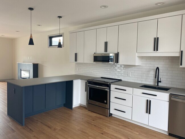 Brand new kitchen with quartz counters and peninsula for seating. - 787 S Division St