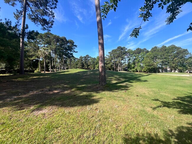 View from screened porch to golf course - 575 Chatham Ct NW