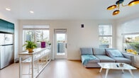 Located in Berkeley, CA, this well-appointed single-floor unit offers a thoughtfully designed layout that balances modern aesthetics with everyday functionality. The open living area is bright and airy, featuring light hardwood flooring, clean white walls, and multiple windows dressed with adjustable blinds that invite ample natural light. A glass door leads out to a private outdoor balcony, extending the living space and providing pleasant views of the surrounding neighborhood and hillside scenery.

The kitchen is a standout feature, showcasing bold teal lower cabinetry with gold-toned hardware paired with crisp white upper cabinets. Stainless steel appliances, including a range and microwave, complement the clean white countertops and light backsplash, creating a functional and visually striking cooking space.

The bedrooms are compact yet well-organized, each outfitted with light hardwood floors, windows offering city and hillside views, and built-in desk areas suited for study or work.

The bathrooms are elegantly finished with classic white penny-tile flooring accented by a dark border, teal vanity cabinetry, white countertops, and illuminated mirrors. Brushed gold fixtures throughout add a refined, cohesive touch. The overall ambiance of the unit is clean, contemporary, and efficiently designed.