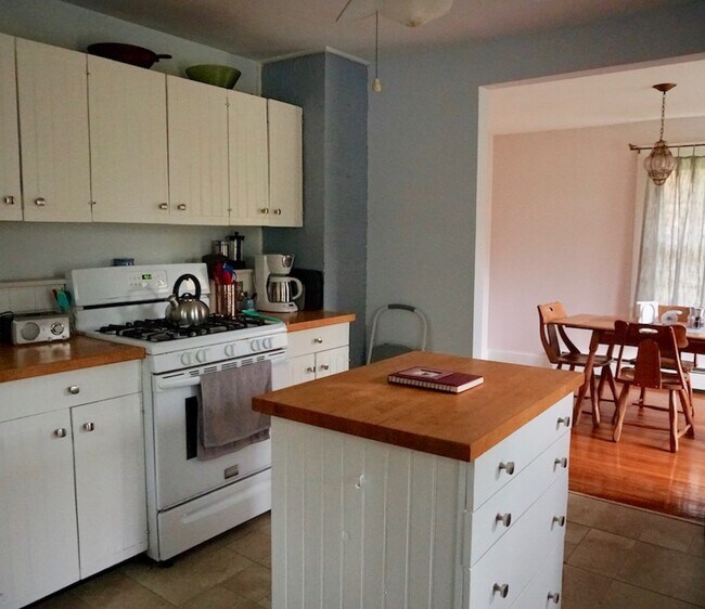 The kitchen now features pine flooring and we have replaced the stove - 1957 County Road 3