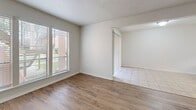 This 1170 square foot apartment, located at 5000 Woodland Dr in New Orleans, offers a well-designed living space across two floors. The lower level, measuring 610 square feet, houses the main living areas, including a galley-style kitchen with white cabinetry, granite countertops, and modern appliances. The living room is a standout feature, boasting a striking stone fireplace that adds character and warmth to the space. 

The upper floor, spanning 550 square feet, accommodates the bedrooms, including the primary suite measuring 170 square feet. All three bedrooms feature plush carpeting and ceiling fans for comfort. The apartment boasts three full bathrooms, each equipped with granite vanity tops and ample storage.

Throughout the home, you'll find a mix of flooring materials, including tile in the kitchen and bathrooms, and hardwood in the main living areas. The apartment also features a private balcony, offering outdoor space for relaxation or entertainment.

Additional amenities include a staircase connecting the two floors and a closet for extra storage. The neutral color palette throughout provides a blank canvas for personalization. This well-appointed apartment combines functionality with comfort, making it an ideal home for families or professionals seeking a spacious living environment in the heart of New Orleans.