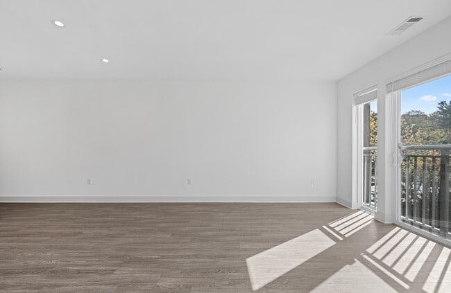 One uninterrupted wall makes furniture placement simple in a corner unit. - The Landing at Vinnin Square