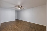 Located at 1350 Greens Pkwy in Houston, TX, this single-floor unit offers a clean, functional layout designed for comfortable everyday living. Warm wood-style flooring runs consistently throughout the space, complementing the crisp white walls and creating a cohesive, inviting atmosphere.

The living area is generously proportioned, with a ceiling fan overhead and an open flow into a bright, windowed dining or secondary sitting area that draws in natural light. This connected layout enhances the sense of openness across the main living spaces.

The bedrooms are well-sized, each equipped with ceiling fans and wood-style flooring. Windows allow natural light to filter in, keeping the rooms airy and comfortable.

The kitchen is a functional standout, featuring rich dark wood cabinetry, light granite-style countertops, a black electric range with overhead ventilation, and a dishwasher — providing ample storage and workspace for cooking.

The bathroom is thoughtfully appointed with a wide granite-style vanity countertop, dark wood cabinetry with brushed nickel hardware, a large mirror, and stylish globe lighting. The space is clean and well-organized, with light flooring that keeps the room feeling fresh.

Overall, this unit presents a practical and well-maintained space with consistent finishes and functional design throughout.