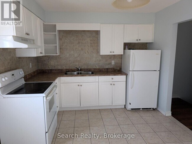 Photo du bâtiment - 311-311 Vesta Rd