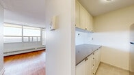 Located at 2001 Carling Ave in Ottawa's west end, this efficiently designed unit offers a well-considered layout across a single floor. The combined kitchen and living area forms the heart of the space, where warm hardwood flooring flows throughout, complemented by crisp white walls and a textured ceiling. A wall of large windows along one side of the living area floods the room with natural light and frames sweeping panoramic views of the Ottawa skyline and surrounding landscape, creating an airy, elevated ambiance enhanced by baseboard heating units below the windows. Access to a balcony further extends the connection to the outdoors. The kitchen is thoughtfully equipped with cream-toned cabinetry — both upper and lower — featuring brass hardware, a grey laminate countertop, stainless steel appliances including a refrigerator and electric range, a single-basin sink, and light tile flooring that cleanly delineates it from the living space. A dedicated closet provides practical storage, while the bathroom offers a clean, functional design with a soaker tub and shower combination finished in white subway tiles accented by neutral grey tile banding, and includes a chrome grab bar for added accessibility. Overall, the space presents a bright, efficient, and comfortable urban living environment.