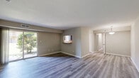 Located at 441 Manor Rd in Newport News, VA, this single-floor, 3-bedroom, 2-bathroom home offers a functional and well-organized layout. The open-concept living and dining area is a central highlight, featuring wood-style plank flooring, neutral-toned walls, and a sliding glass door that fills the space with natural light and provides views of the surrounding greenery. A distinctive pass-through window with a granite-style ledge connects the living area to the kitchen, creating a convenient and social flow between spaces. The kitchen includes dark cabinetry and is complemented by a pantry for additional storage. The generously sized primary bedroom features plush carpeting, a dedicated closet, and a private en-suite bathroom. The en-suite includes a stylish vanity with dark cabinetry, a white countertop, and a tub/shower combination. Two additional bedrooms, also carpeted and well-lit by natural light, share a second full bathroom. The home further includes a hallway connecting the private quarters, a dedicated laundry area, and four closets distributed throughout for ample storage. The overall ambiance is clean, neutral, and move-in ready.