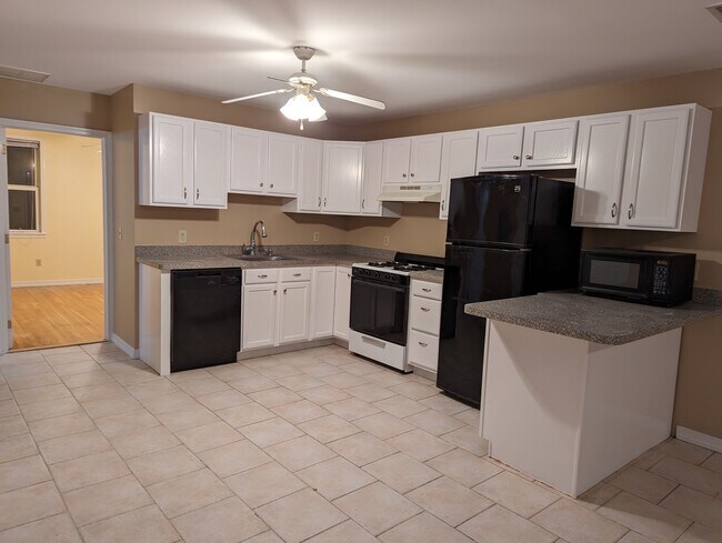 Kitchen: dishwasher, gas stove with hood, many cabinets, barstool seating, microwave included - 111 Hancock Ave