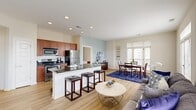 This thoughtfully designed 2-bedroom, 2-bathroom residence in Hampton, Virginia offers a smart, efficient layout across a single floor. The open-concept kitchen, living, and dining area forms the heart of the home, where light hardwood flooring, recessed lighting, and a soft neutral palette create a bright and welcoming atmosphere. The kitchen is equipped with stainless steel appliances, rich wood cabinetry, dark granite countertops, and a peninsula with bar seating — ideal for both cooking and casual dining. The dining area is bathed in natural light from large French doors and floor-to-ceiling windows that open to an outdoor view, while the living room features a soft blue accent wall and additional window access. The spacious primary bedroom offers plush carpeting, generous closet space, and an en-suite bathroom with a wood vanity, soaking tub, and tile flooring. The second bedroom is equally comfortable, with its own soothing accent wall and soft carpet. A second full bathroom provides a tub-shower combination with a clean, neutral finish. Three closets throughout the unit offer ample storage. With an entrance foyer, dedicated hallway, and a well-organized floor plan, this residence balances functionality with comfort in every detail.
