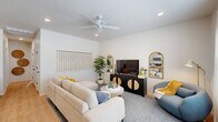 Located at 1800 NW 115th Terr in Oklahoma City, OK, this single-story 2-bedroom, 2-bathroom home offers a thoughtfully designed layout with modern finishes and a bright, welcoming ambiance. The open-concept living room features light-toned walls, wood-style flooring, recessed lighting, and a ceiling fan, creating a comfortable and airy atmosphere. Large windows allow natural light to fill the space, complemented by a stylish media console and ample seating area. The kitchen is well-equipped with white shaker-style cabinetry, stainless steel appliances including a refrigerator, electric range, and microwave, and a white quartz peninsula with bar seating — ideal for casual dining and entertaining. Wood-style flooring extends throughout, adding warmth and continuity. The primary bedroom is a comfortable retreat featuring multiple windows, a ceiling fan, and generous closet storage. The second bedroom provides a cozy space with hardwood-style floors and bright walls. Both bathrooms are finished with gray cabinetry, white quartz countertops, and tub-shower combinations accented by large-format marble-style tile. Two dedicated closets provide practical storage solutions throughout the home.