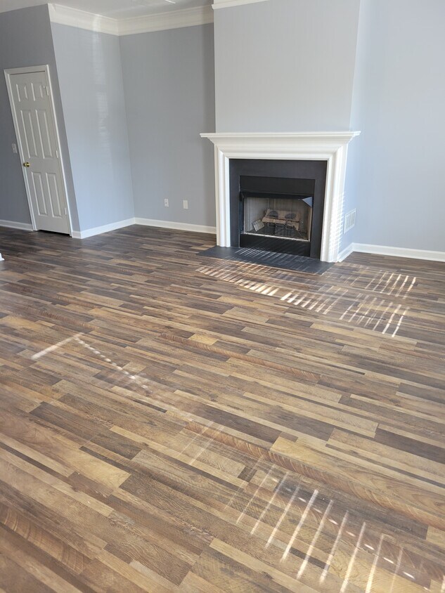 living room w/ fireplace luxury vinyl flooring - 3779 Town Square Cir NW