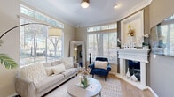 This single-floor residence offers a thoughtfully designed layout that balances comfort and style throughout. The welcoming entryway, framed by a classic paneled front door, opens to warm hardwood-style flooring and neutral-toned walls that carry throughout the main living areas.

The living room is a standout space, bathed in abundant natural light from large windows adorned with wood blinds and transom windows above. Crown molding adds an elegant touch, while a white decorative fireplace serves as a charming focal point. The room's generous proportions comfortably accommodate both lounging and entertaining.

The kitchen is well-equipped and functional, featuring rich dark cabinetry, a mosaic tile backsplash, light countertops, and a full suite of stainless steel appliances. Ample cabinet storage extends to the upper walls, maximizing utility, and a window above the sink invites natural light into the space.

The bedrooms offer a cozy retreat, with plush carpeting, natural light from well-placed windows, and closet storage. The bathroom is thoughtfully appointed with a soaking tub and shower combination, dark wood vanity cabinetry, and a clean, neutral palette throughout.

A dedicated laundry area is accessible from the kitchen, adding practical convenience to this comfortable and cohesive home.