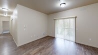 Located at 10436 SE Carr Rd in Renton, WA, this well-appointed 3-bedroom, 2-bathroom single-floor home offers a comfortable and functional layout. The open-concept living, dining, and kitchen area serves as the heart of the home, featuring warm wood-tone cabinetry, stainless steel appliances, a double sink, and generous counter space with a breakfast bar. Wood-look flooring flows throughout the main living areas, while plush carpet adds warmth to the bedrooms. The spacious primary bedroom includes its own dedicated closet space, and the additional bedrooms each feature sliding panel closets. With six closets total, storage is abundant throughout. Both bathrooms are finished with rich wood vanities, stone-look tile flooring, and well-lit mirrors. Two balconies with sliding glass doors bring in natural light and provide outdoor access, offering views of the surrounding greenery. A dedicated laundry area and a connecting hallway complete the thoughtfully designed floor plan. The neutral color palette and clean architectural lines create a bright, move-in-ready atmosphere suited for a range of lifestyles.