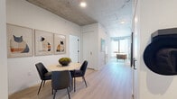 Located at 625 N 2nd Ave in the heart of Phoenix's vibrant Roosevelt Row Arts District, this thoughtfully designed 2-bedroom, 2-bathroom residence combines urban industrial aesthetics with modern comfort. Exposed concrete ceilings run throughout, creating a striking architectural contrast against crisp white walls and light-toned wood plank flooring.

The open-concept living, dining, and kitchen area serves as the centerpiece of the home. The kitchen is outfitted with dark cabinetry, white quartz countertops, a white subway tile backsplash, and a full suite of stainless steel appliances, including a gas range. A cozy dining nook flows naturally into the living room, which is anchored by a large picture window offering expansive city views and abundant natural light.

Both bedrooms are well-proportioned and feature exposed concrete column accents, adding to the industrial character of the space. Each bedroom benefits from multiple closets for generous storage. The two bathrooms mirror one another in their refined design, featuring walk-in tile showers with rainfall showerheads, floating wood vanities, white quartz countertops, and backlit mirrors. Large-format floor tiles complete the clean, contemporary look.

Additional highlights include an in-unit laundry area, further enhancing the convenience of this well-appointed urban residence.