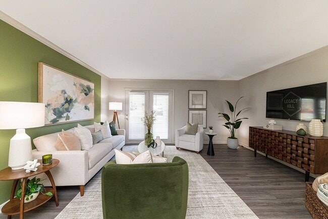 Spacious living room with hardwood-style flooring - Legacy Hill
