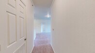 Located at 2401 Lakeview Rd in North Little Rock, Arkansas, this single-floor residence offers a well-organized layout with 2 bedrooms and 2 full bathrooms. The interior is finished with neutral tones throughout, featuring soft carpeting in the living areas and bedrooms, while the kitchen, bathrooms, and laundry areas are laid with warm wood-look vinyl flooring.

The kitchen is equipped with warm oak-toned cabinetry, light stone countertops, white appliances including a coil-top range, refrigerator, and dishwasher, all complemented by an under-cabinet range hood. A hallway connects the main living spaces, leading to the dining room and carpeted living room.

Both bedrooms are generously sized with plush carpeting, ample natural light, and ceiling fixtures. The primary bedroom offers a comfortable footprint with its own closet space. The four closets distributed throughout the unit provide substantial storage. The two full bathrooms are clean and functional, each featuring a tub/shower combo, toilet, and vanity with storage cabinetry.

A dedicated laundry room includes washer and dryer hookups along with an overhead wire shelf. A utility room adds further practical storage. Crown molding details are visible in the hallway, adding a refined touch to the overall clean and move-in ready aesthetic.