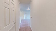 Located at 2401 Lakeview Rd in North Little Rock, Arkansas, this single-floor residence offers a well-organized layout with 2 bedrooms and 2 full bathrooms. The interior is finished with neutral tones throughout, featuring soft carpeting in the living areas and bedrooms, while the kitchen, bathrooms, and laundry areas are laid with warm wood-look vinyl flooring.

The kitchen is equipped with warm oak-toned cabinetry, light stone countertops, white appliances including a coil-top range, refrigerator, and dishwasher, all complemented by an under-cabinet range hood. A hallway connects the main living spaces, leading to the dining room and carpeted living room.

Both bedrooms are generously sized with plush carpeting, ample natural light, and ceiling fixtures. The primary bedroom offers a comfortable footprint with its own closet space. The four closets distributed throughout the unit provide substantial storage. The two full bathrooms are clean and functional, each featuring a tub/shower combo, toilet, and vanity with storage cabinetry.

A dedicated laundry room includes washer and dryer hookups along with an overhead wire shelf. A utility room adds further practical storage. Crown molding details are visible in the hallway, adding a refined touch to the overall clean and move-in ready aesthetic.