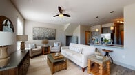 This single-story 2-bedroom residence at The Preserve in Bowling Green, Kentucky, offers a thoughtfully designed open-concept layout with contemporary finishes and a warm, neutral aesthetic throughout. The living area is generously proportioned, featuring vaulted ceilings, a ceiling fan, and large windows that invite abundant natural light. The space flows seamlessly into a well-equipped kitchen outfitted with slate-gray shaker cabinets, granite countertops, stainless steel appliances, a hexagonal tile backsplash, and a peninsula with pendant lighting — ideal for both everyday use and entertaining.

The primary bedroom is a comfortable retreat with carpeted flooring, a ceiling fan, and a window offering outdoor views. Its ensuite bathroom features a dual-sink vanity with granite countertops, navy cabinetry, wood-look flooring, a backlit mirror, and access to a spacious walk-in closet with built-in shelving. The second bedroom is equally inviting with carpeted floors, a window, and ceiling fan. A second full bathroom includes a granite vanity, wood-look flooring, and a tiled tub-shower combination. Throughout the residence, the consistent use of warm neutrals and quality materials creates a cohesive and comfortable living environment.