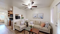 Located at 431 E Prince Rd in Tucson, AZ, this single-story, one-bedroom, two-bathroom unit offers a thoughtfully organized layout that maximizes every square foot of its compact footprint. The living room serves as the welcoming heart of the home, featuring wood-look flooring, a ceiling fan with light fixture, and a bright entry area with a windowed door that brings in natural light. A pass-through opening connects the living space to the galley-style kitchen, which is outfitted with warm wood cabinetry, marble-pattern countertops, a double sink, and black appliances including a refrigerator, electric range, microwave, and dishwasher — providing a fully functional cooking space. The bedroom offers a comfortable retreat with plush carpet, a ceiling fan, and a natural window view. It features dual closets, providing generous storage for the room's size. Two bathrooms serve the unit, each with wood-look flooring, vanity cabinetry, and marble-style countertops. A programmable thermostat is conveniently located near one of the bathrooms. Clean white walls and consistent finishes throughout create a cohesive, move-in-ready atmosphere well-suited for Tucson's desert lifestyle.