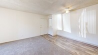 Located on East Golf Links Road in Tucson, Arizona, this one-bedroom, one-bathroom unit offers a practical and efficient layout across a single floor. The living room is bright and open, featuring a mix of soft carpeting and wood-look vinyl flooring, a ceiling fan, and a sliding glass door that floods the space with natural light and provides access to the outdoors. Textured ceilings are consistent throughout the unit, adding a classic residential character.

The galley-style kitchen is thoughtfully arranged with warm oak cabinetry lining both sides, light countertops, a double-coil electric range, a refrigerator, a dishwasher, and a stainless steel sink — maximizing storage and functionality within a compact footprint.

The bedroom is carpeted and comfortably sized, featuring a large window that invites natural light and offers exterior views. A full-sized closet with bi-fold doors provides ample storage space.

The bathroom includes a tub-shower combination with a curtain, a wood-toned vanity with an integrated sink, and wood-look flooring that ties cohesively to the rest of the unit.

Overall, the unit presents a clean, neutral palette throughout, making it a versatile and move-in ready space well-suited for those seeking a streamlined, low-maintenance living environment in Tucson.