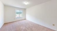 Located at 350 Snyder Way in Radcliff, Kentucky, this single-floor, 2-bedroom, 1-bathroom residence offers a practical and comfortable layout. The interior features warm neutral tones throughout, with wall-to-wall carpeting across the living areas and bedrooms, complemented by clean white walls and wood-toned trim and cabinetry.

The kitchen opens to the living area via a pass-through counter with warm wood-panel detailing, creating a connected and functional space. The kitchen is equipped with essential appliances including a range and refrigerator, with overhead cabinetry providing ample storage.

Both bedrooms are carpeted and well-proportioned. The primary bedroom features a set of wood bi-fold closet doors and a window overlooking the outdoors, bringing in natural light and views of the surrounding greenery. The second bedroom also includes a dedicated closet and a window, maintaining a bright and airy feel. A hallway connects the bedrooms, with additional closet storage accessible along the corridor.

The bathroom is finished with tile flooring, a vanity with wood-accented cabinetry, a tub/shower combination, and clean white fixtures throughout. The overall design is straightforward and functional, offering a comfortable living environment in a residential Radcliff neighborhood.