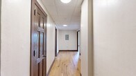 Located at 324 N Vermilion Street in Danville, Illinois, this 2-bedroom, 1-bathroom unit offers a well-organized single-floor layout designed for comfortable everyday living. Warm, light-toned hardwood flooring flows consistently throughout every room, complemented by clean white walls, crown molding, and rich dark wood baseboards and door frames that add a classic character to the space.

The spacious primary bedroom features two large grid-pane windows that invite abundant natural light and offer views of the surrounding neighborhood. The second bedroom is equally well-lit, with its own window and direct access to a dedicated closet. Both rooms are connected via a central hallway, creating a functional and logical flow through the unit.

The kitchen is well-appointed with rich dark wood cabinetry, white countertops, a tile backsplash, a double-basin sink, and stainless steel appliances including a range with oven and a full-size refrigerator. Crown molding carries through into the kitchen, maintaining a cohesive aesthetic throughout.

The bathroom is clean and straightforward, featuring a full tub-shower combination with built-in shelving and chrome fixtures, a toilet, and a vanity. The unit's layout, consistent finishes, and natural light make it a practical and comfortable living space.