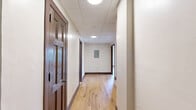 Located at 324 N Vermilion Street in Danville, Illinois, this 2-bedroom, 1-bathroom unit offers a well-organized single-floor layout designed for comfortable everyday living. Warm, light-toned hardwood flooring flows consistently throughout every room, complemented by clean white walls, crown molding, and rich dark wood baseboards and door frames that add a classic character to the space.

The spacious primary bedroom features two large grid-pane windows that invite abundant natural light and offer views of the surrounding neighborhood. The second bedroom is equally well-lit, with its own window and direct access to a dedicated closet. Both rooms are connected via a central hallway, creating a functional and logical flow through the unit.

The kitchen is well-appointed with rich dark wood cabinetry, white countertops, a tile backsplash, a double-basin sink, and stainless steel appliances including a range with oven and a full-size refrigerator. Crown molding carries through into the kitchen, maintaining a cohesive aesthetic throughout.

The bathroom is clean and straightforward, featuring a full tub-shower combination with built-in shelving and chrome fixtures, a toilet, and a vanity. The unit's layout, consistent finishes, and natural light make it a practical and comfortable living space.