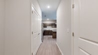 This well-appointed 2-bedroom, 2-bathroom unit at 3400 Tevis Dr. in Louisville, Kentucky offers a comfortable and modern single-floor layout. Light wood-style flooring flows seamlessly throughout the space, complemented by neutral-toned walls that create a bright, clean aesthetic.

The kitchen is a standout feature, showcasing rich dark-toned cabinetry, granite countertops, a white subway tile backsplash, and a full suite of stainless steel appliances including a range, microwave, refrigerator, and dishwasher. A peninsula with pendant lighting provides additional prep space and casual dining potential, while the open layout connects effortlessly to the living area.

The generously sized primary bedroom includes a walk-in closet outfitted with wire shelving and hanging rods for organized storage. The second bedroom is equally well-lit, featuring a window with blinds and the same durable flooring. Two closets throughout the unit offer ample storage.

The two bathrooms are finished with granite-topped dark wood vanities and tile flooring. The primary bath features a glass-enclosed walk-in shower with white subway tile, while the second bath includes a full tub-shower combo. Clean lines and consistent finishes give both bathrooms a polished, contemporary feel.