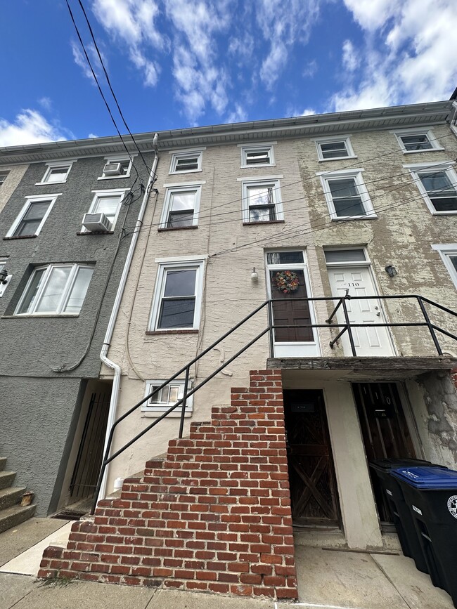 front view of the house. bottom door is entrance to basement. - 112 W 1st Ave
