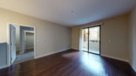 Located at 1987 Bridgepointe Cir in San Mateo, California, this well-appointed single-floor residence offers a thoughtfully designed layout with a clean, contemporary aesthetic throughout. The main living area is anchored by rich, dark hardwood flooring that reflects natural light streaming in through large sliding glass doors, which open to a private balcony with views of the surrounding landscaped community. Neutral-toned walls and crisp white trim create a bright, open ambiance.

The kitchen is outfitted with a full suite of stainless steel appliances, including a french-door refrigerator with ice maker, electric range, and microwave, all complemented by modern flat-front cabinetry in a warm wood-tone finish and light quartz countertops. The continuous hardwood flooring ties the kitchen seamlessly to the living space.

The bedrooms feature plush carpeting and generous windows that invite natural light and outdoor views of the community grounds. One bedroom includes access to a walk-in closet. The bathrooms are finished with contemporary wood-tone vanities, white quartz countertops, framed mirrors, and tub-shower combinations, with hardwood-style flooring reinforcing the cohesive design. The space strikes a comfortable balance between modern finishes and functional, everyday livability.