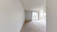 Located at 4901 Bottleneck Ln in Orlando, FL, this single-floor, one-bedroom, one-bathroom unit offers a practical and efficiently designed layout. The combined kitchen and living room area serves as the heart of the home, where soft carpet flows underfoot and a sliding glass door opens to a private balcony, allowing natural light and outdoor views to fill the space. A separate dining area provides a dedicated spot for meals just off the main living zone.

The galley-style kitchen is outfitted with white cabinetry, light stone-patterned countertops, white appliances including an electric range and refrigerator, a dishwasher, and a stainless steel sink. Light-toned luxury vinyl plank flooring runs throughout the kitchen, creating a clean contrast to the carpeted living areas.

The bedroom is a comfortable, carpeted retreat featuring a window with outdoor views and a ceiling fan. A closet provides dedicated storage, and the room connects conveniently to the rest of the unit. The bathroom includes a vanity with a granite-style countertop, white cabinetry, a large mirror, and tile flooring. Neutral gray walls and textured ceilings are consistent throughout, giving the unit a cohesive, understated aesthetic. An entrance area completes the thoughtful floor plan.