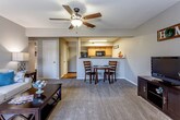 Located at 12087 S Black Bob Rd in Olathe, Kansas, this single-floor residence offers a thoughtfully designed layout that balances comfort and functionality. The open-concept living area serves as the heart of the home, featuring neutral-toned carpet, a ceiling fan with a light fixture, and a sliding glass door that fills the space with natural light while providing access to an outdoor balcony. The living area flows seamlessly into a dining space, creating an inviting atmosphere for everyday living and entertaining.

The kitchen is positioned adjacent to the main living area and features warm wood cabinetry, laminate countertops, a full suite of black appliances, and durable hardwood-style flooring. A breakfast bar connects the kitchen to the dining area, enhancing the open feel.

The unit includes multiple carpeted bedrooms, each offering natural light through windows with blinds. The primary bedroom benefits from multiple windows and a walk-in closet. Additional bedrooms also include closet storage. Two full bathrooms serve the residence, each featuring tile-style flooring, a vanity with wood cabinetry, and a shower with curtain enclosure, providing practical and comfortable amenities throughout.