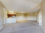 This well-appointed 2-bedroom, 2-bathroom residence in Sioux Falls, SD offers a thoughtfully designed single-floor layout with a warm, neutral color palette throughout. The open living area welcomes you with plush carpeting, vaulted ceilings, and a ceiling fan, flowing seamlessly into the kitchen and dining space. The kitchen is equipped with rich dark-wood cabinetry, stainless steel appliances including a refrigerator, range, and over-the-range microwave, and a convenient breakfast bar with light countertops. Light hardwood-style flooring runs through the kitchen and extends toward the dedicated laundry room, which includes an in-unit washer and dryer. The spacious primary bedroom features soaring vaulted ceilings, a ceiling fan, plush carpeting, and a large window that fills the room with natural light and outdoor views. The primary bathroom includes a vanity with dark wood cabinetry, a tub/shower combo, and tile flooring, with direct access to a generous walk-in closet with built-in shelving. The second bedroom also enjoys vaulted ceilings, a ceiling fan, and natural light. A second full bathroom mirrors the same clean, functional design. A sliding glass door from the living area opens to a private balcony, adding an inviting outdoor extension to the space.