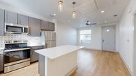Located at 5702 Melrose Ave in San Angelo, TX, this thoughtfully designed one-bedroom, one-bathroom unit offers a efficient and modern single-floor layout. Light wood-tone flooring flows seamlessly throughout every room, creating a warm, cohesive aesthetic.

The open-concept kitchen and living area serves as the heart of the unit. The kitchen is equipped with a full suite of stainless steel appliances, including a refrigerator, range, microwave, and dishwasher. Taupe-gray cabinetry pairs with a white quartz island and a decorative patterned tile backsplash for a contemporary look. Pendant lights hang above the island, while the adjoining living area features recessed lighting, a ceiling fan, and natural light from a window near the front entry door.

The bedroom is a comfortable, well-proportioned space with a ceiling fan, a window for natural light, and a sliding barn door leading to a dedicated closet. The full bathroom features matching gray cabinetry with a white countertop, a tub/shower combination, and wood-look flooring that continues from the main living areas.

Additional conveniences include an in-unit laundry area and a private patio. The clean, neutral palette and modern finishes throughout make this a functional and attractive space.