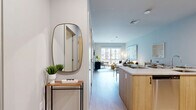 Located at 301 Winchester Ave in New Haven, CT, this well-appointed one-bedroom, one-bathroom residence offers a thoughtfully designed open-concept layout finished with light hardwood flooring and a neutral, contemporary palette throughout. The combined kitchen and living area serves as the heart of the home, where the kitchen features light wood cabinetry, stainless steel appliances including a full-size refrigerator, electric range, and over-the-range microwave, all complemented by clean white countertops. The living area is bathed in natural light from large windows that frame views of the surrounding neighborhood, creating a bright and welcoming atmosphere. The bedroom is a comfortable retreat, offering generous proportions, wide windows with abundant natural light, and a serene, airy ambiance with soft neutral tones. A dedicated walk-in closet with wire shelving and hanging rods provides practical storage. The full bathroom is finished with tile flooring, a wood-accented vanity with a white countertop, and a full tub-shower combination. The overall design of the residence is clean, modern, and functional, making it an inviting home in the heart of New Haven.