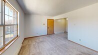 Located at 6300 West Bancroft Street in Toledo, Ohio, this single-floor, two-bedroom, one-bathroom unit offers a practical and well-organized layout. The space includes a kitchen, living room, two bedrooms, a full bathroom, and a dedicated closet.

The kitchen is equipped with warm-toned oak cabinetry, light stone-patterned countertops, a double-basin sink, and stainless steel appliances including a refrigerator and an electric range with an overhead exhaust hood. Light wood-style flooring runs throughout the kitchen, giving it a clean, functional feel.

The living room features neutral-toned carpet, a textured ceiling, and baseboard heating, providing a comfortable and versatile space. The primary bedroom is generously sized, offering carpet flooring, a sliding wood-panel closet, and access to additional areas of the unit. The second bedroom also features carpet flooring, a window that brings in natural light, and baseboard heating.

The bathroom includes a full tub-shower combination with chrome fixtures and a towel bar, complemented by clean white finishes throughout. Both bedrooms and the living areas maintain a consistent, neutral aesthetic with white walls and warm wood trim accents, creating a cohesive and move-in-ready environment throughout the unit.