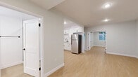 Located in the heart of West Hollywood, this thoughtfully designed 2-bedroom, 2-bathroom unit offers a clean, modern aesthetic throughout. Light wood-style flooring flows seamlessly across the entire floor plan, complementing the soft gray-white walls and crisp white trim that give the space a bright, cohesive feel.

The open kitchen is a standout feature, boasting white shaker cabinetry with black hardware, white quartz countertops, and a full suite of stainless steel appliances including a range, over-the-range microwave, dishwasher, and refrigerator. The layout connects naturally to the living area, making the space feel open and functional.

Each bedroom is well-proportioned and filled with natural light from large windows dressed with vertical blinds that offer views of surrounding greenery. The primary bedroom includes a mirrored sliding closet and a dedicated wall-mounted mini-split system for individualized climate control. Both bedrooms share this modern cooling solution.

The bathrooms are finished in a sleek contemporary style, with one featuring a glass-enclosed walk-in shower with white subway tile, a white vanity, and matte black fixtures. A dedicated laundry area with a stacked washer/dryer and cabinetry adds everyday convenience. Recessed lighting throughout completes this move-in-ready home.