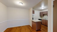 Located at 10500 Hackberry Drive in Sappington, MO, this single-floor unit offers three bedrooms and one full bathroom within a efficiently organized layout. The spacious primary bedroom is a standout feature, boasting plush carpeting, a large window that invites natural light and outdoor views, and a sliding glass door that opens onto a private balcony overlooking greenery. Two additional bedrooms are well-proportioned, each featuring neutral-toned carpet, natural light from windows, and sliding-panel closets with distinctive mauve-colored doors. The living area transitions seamlessly into a dining space, where warm hardwood flooring and yellow-accented walls create a welcoming ambiance. A hallway connects the main living areas to the bedrooms, maintaining a practical flow throughout the unit. The kitchen is compact and functional, equipped with a stovetop and ample cabinetry. The full bathroom features a classic white tiled tub-shower combination with chrome fixtures, offering a clean and timeless aesthetic. Throughout the unit, neutral wall tones and consistent finishes contribute to a cohesive, move-in-ready feel.