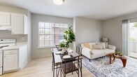 Located at 1805 Aquarena Springs Dr in San Marcos, TX, this one-bedroom, one-bathroom unit offers a thoughtfully organized single-floor layout that maximizes every square foot. The open-concept living and dining area serves as the heart of the unit, featuring light wood-tone flooring, neutral gray walls, and large windows that invite natural light throughout. A sliding glass door opens to a private balcony, extending the living space and providing outdoor views. The dining area comfortably accommodates a full dining set and flows seamlessly into the living room, creating a cohesive, functional shared space. The galley-style kitchen is clean and well-appointed, featuring white cabinetry, light countertops, a stainless steel sink, and white appliances including a coil-top range and refrigerator. A hallway connects the main living areas to the private bedroom and bathroom. The bedroom is a cozy, windowed retreat with a ceiling fan and light wood flooring. The full bathroom includes a tiled shower-tub combination, toilet, and vanity, finished in a clean, neutral palette. The unit's straightforward layout, consistent flooring, and bright, understated design make it a practical and comfortable living space in San Marcos.