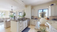 Located at 2121 S Hiawassee Rd in Orlando, Florida, this single-floor residence offers a thoughtfully designed layout with refined architectural details and a warm, neutral palette throughout. Crown molding, travertine tile flooring, and abundant natural light lend an air of sophistication to every room.

The gourmet kitchen is a standout feature, showcasing antique white raised-panel cabinetry, rich granite countertops, a center island, a stone tile backsplash, and stainless steel appliances including a gas range, microwave, and dishwasher. Large windows bring in generous natural light, creating an inviting workspace.

The open living and dining area is bathed in light from full-height French doors that frame sweeping outdoor views. A gas fireplace anchors the living space, while an elegant pendant light defines the dining area. The seamless flow between these spaces makes the area ideal for both everyday living and entertaining.

The bedrooms are serene and well-appointed, with plush carpeting, crown molding, and ample closet space. Each bedroom benefits from natural light, with select rooms offering direct access to a balcony with scenic views.

The bathrooms feature travertine tile, glass-enclosed showers, soaking tubs, and white vanities with warm-toned countertops and gold-accented mirrors, completing the space's consistently elegant aesthetic.