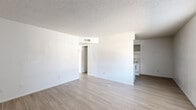 Located at 6801 N 25th Dr in Phoenix, Arizona, this single-floor, 2-bedroom, 1-bathroom unit offers a straightforward and efficient layout designed for comfortable everyday living. Light wood-style flooring runs consistently throughout the space, creating a cohesive and clean aesthetic.

The living room serves as the central gathering area, featuring white walls, a textured ceiling, and a large window with vertical blinds that allows natural light to fill the room. A front entry door is positioned nearby, providing a welcoming entry point.

The galley-style kitchen is neatly arranged with gray upper cabinetry, a white electric range, an over-range microwave hood, a refrigerator, and light countertops — offering all the essentials in a compact and organized footprint.

Both bedrooms are bright and simply appointed, each with white walls, textured ceilings, and windows fitted with vertical blinds that invite natural light. The primary bedroom includes a closet, providing dedicated storage. A hallway connects the bedrooms to the rest of the unit, with two closets offering additional storage solutions.

The bathroom features a full tub-shower combo, a toilet, and a vanity with a light countertop and under-sink cabinetry, finished with wood-style flooring consistent with the rest of the home. The overall ambiance is clean, neutral, and move-in ready.